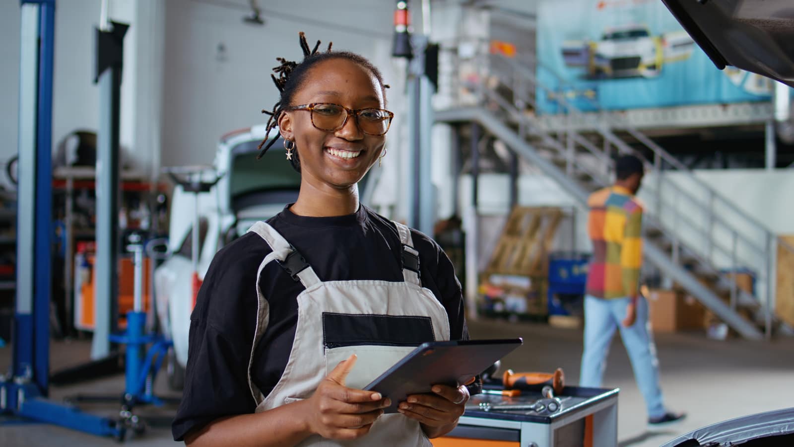 Shop staff managing stock on a tablet